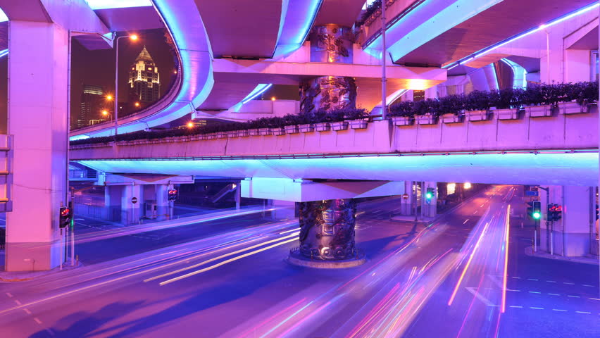 Busy traffic in downtown Shanghai, China. Highway illuminated by violet lights. 