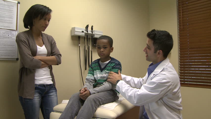Male doctor examines sick child (3 of 4)
