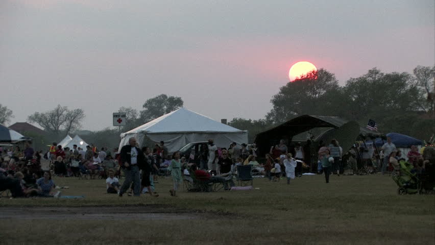 The annual San Antonio Texas Fiesta event at Fort Sam Houston Army Post at sunset. Individuals and families move around.