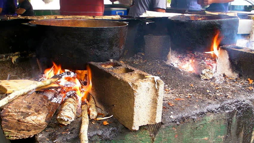 Roadside Indigenous cooking in big iron pans and fire