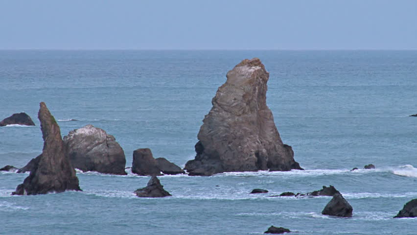Sea stacks, monuments of past geologic events, protrude from the Pacific ocean just offshore in Northern California waters.