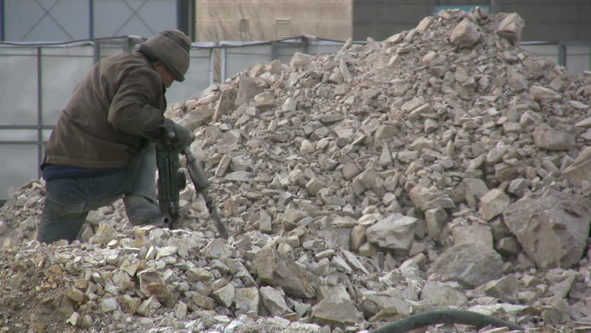 QINGDAO - MARCH 19: A worker is drilling at a construction site on March 19, 2010 in Qingdao, China.