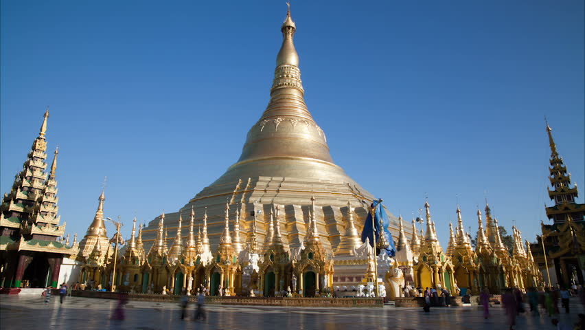 Late afternoon golden color change of the biggest Buddhist temple Shwedagon pagoda with walking people. Rangoon, Burma. Time lapse, 30 fps progressive version.