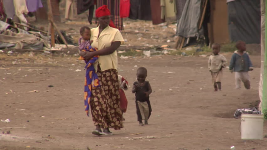 KENYA - CIRCA 2006: Unidentified African woman walks up a street followed by toddlers circa 2006 in Kenya.