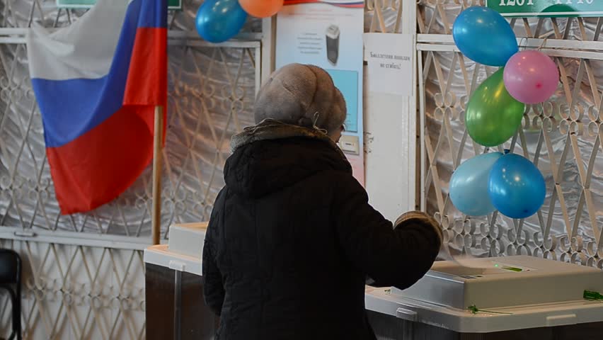 ULAN-UDE, RUSSIA - MARCH 4: Voters at the local polling station 699 stand in line to voting booths at the presidential election of Russian Federation on March 4, 2012 in Ulan-Ude, Buryatia, Russia.