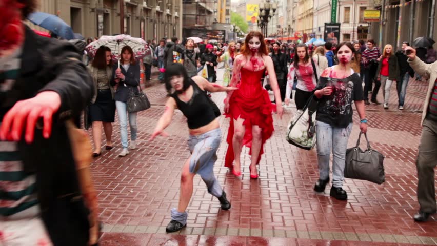 MOSCOW - MAY 14: Bloody zombies girls walk by street among people during Zombie Parade on May 13, 2011 in Moscow, Russia.