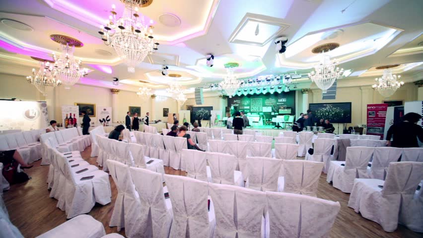 MOSCOW - APRIL 25: Several people sit on white chairs in conference hall at Wine People Trophy Russia 2011 on April 25, 2011 in Moscow, Russia.
