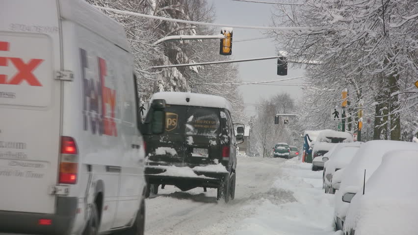 VANCOUVER, CANADA â DEC 24: Delivery trucks in Vancouver, British Columbia, Canada, Dec 26, 2008. Consecutive storms over the holiday season, broke snowfall records in many parts of western Canada. 
