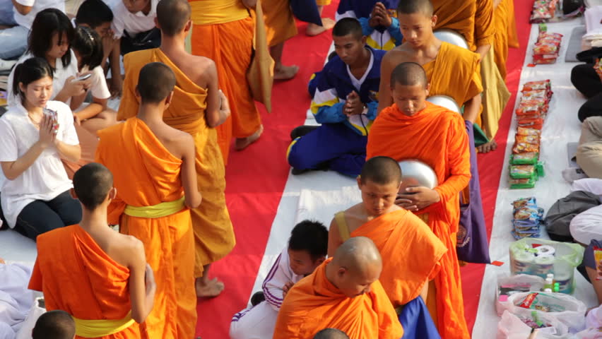 BANGKOK - MARCH 18: Monks are participating in a Mass Alms Giving of 12,600 monks in Central World for the Makha Bucha celebrations on March 18, 2012 in Bangkok, Thailand.