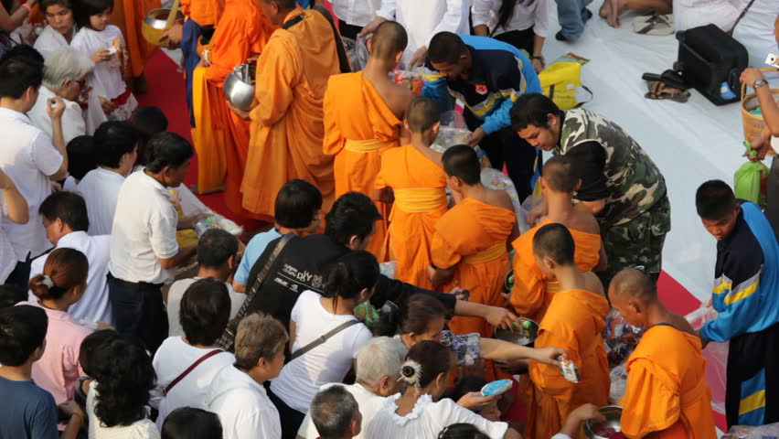 BANGKOK - MARCH 18: Monks are participating in a Mass Alms Giving of 12,600 monks in Central World for the Makha Bucha celebrations on March 18, 2012 in Bangkok, Thailand.