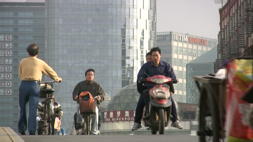 SHANGHAI - JUNE 1: Early morning commuters make their way through the streets of Shanghai, China on June 1, 2010. 