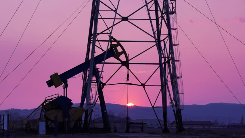 Oil Derrick mechanism in the sunset