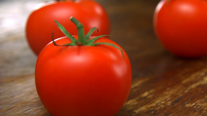 Super close-up ripe tomatoes with water splash