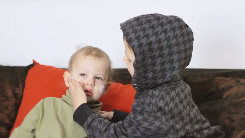 Cosmetic children's game. Video clip shows the small children who are smearing cream. Clip ID: children3_HD