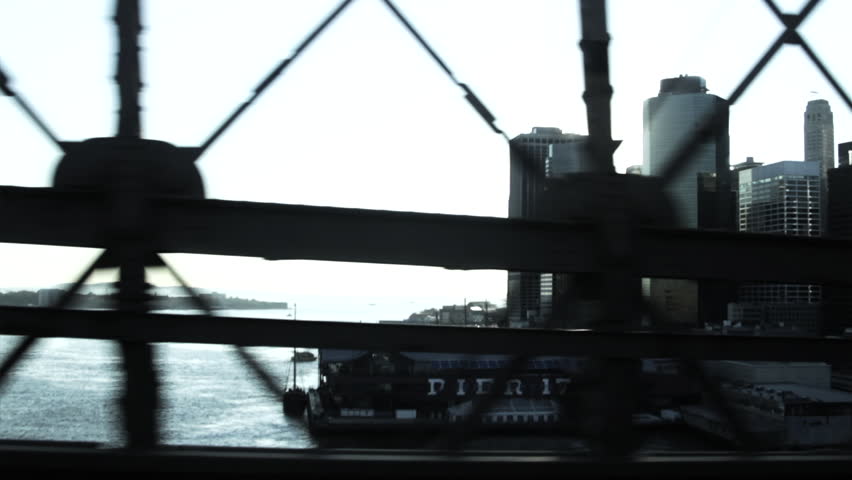 Car crossing East River with Manhattan Financial District and Brooklyn Bridge, New York City, USA