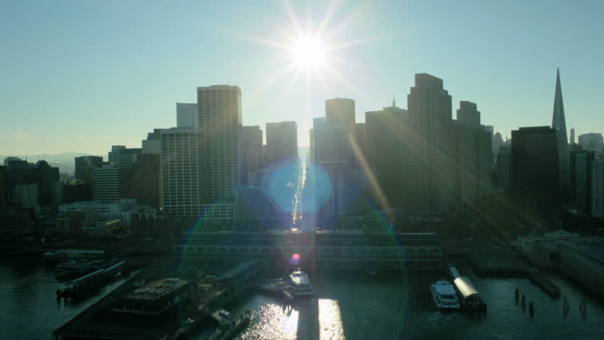 Aerial low angle sunlight view of Fishermans Wharf port area and San Francisco, North America, USA