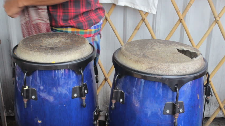 Man plays conga drums