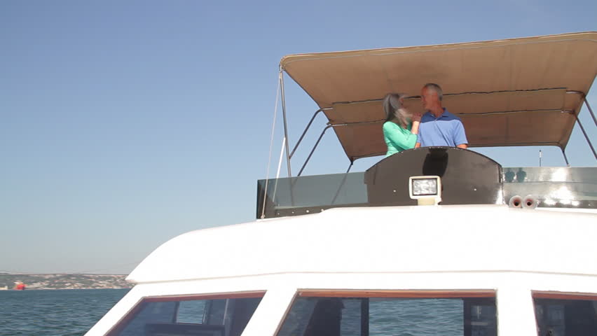 Senior male captain and female boating on a boat