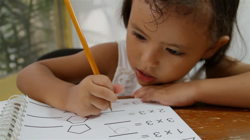 Hispanic Girl With Math Homework (HD). Four year old Hispanic girl doing some math homework. Book pages are original custom made for the shoot so no copyright problems. 
