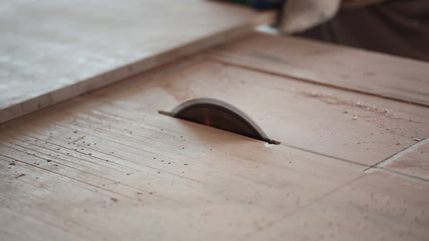 carpentry. circular saw cutting a wood plank