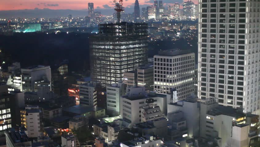 Aerial view of high-rise office buildings and residential area in downtown Tokyo, Japan during sunset