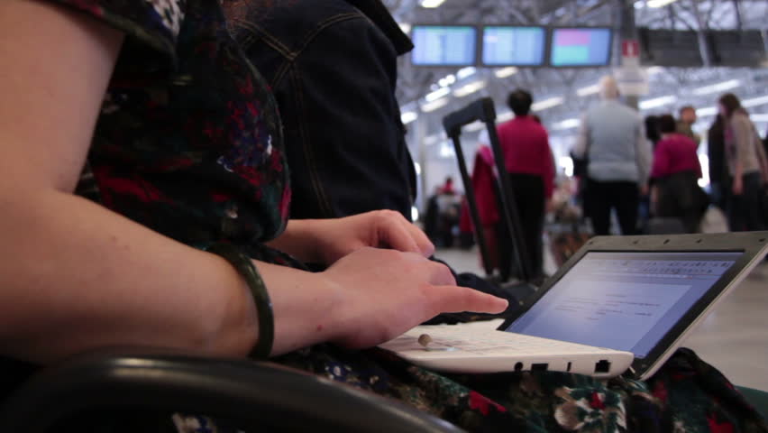 Woman using laptop at airport  - Airline passengers at the airport