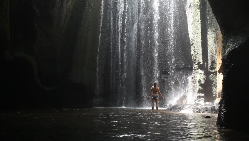 Woman In A Bikini Drinking Water By Waterfall Stock Footage Video 1312873 Shutterstock 2930