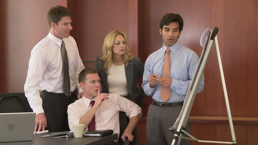 Young business man making presentation to coworkers