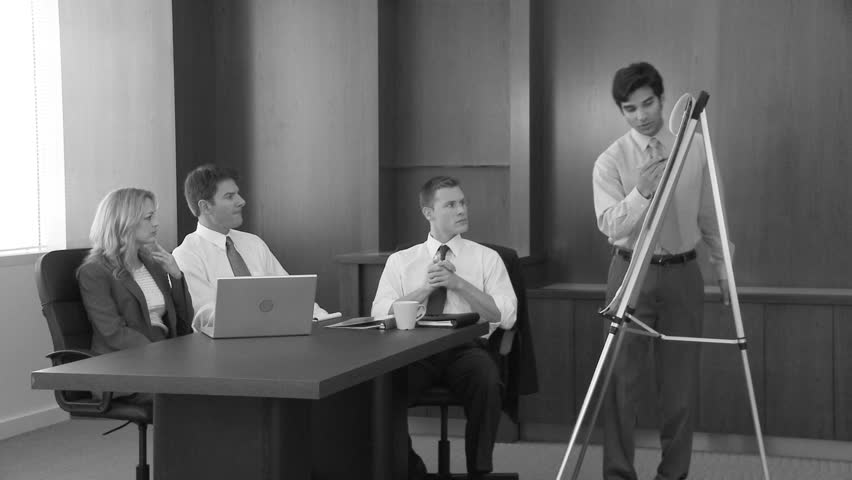 Young business man making presentation to coworkers