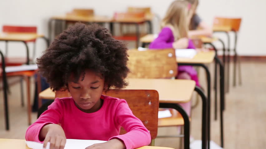 Pupil sitting at a table in the classroom