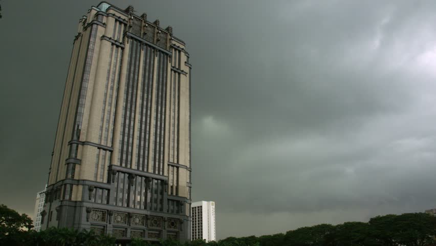 Singapore - Circa 2010: The Parkview Square building 2010. Timelapse tilt up of the Parkview Square building against an overcast sky in Singapore, Asia.
