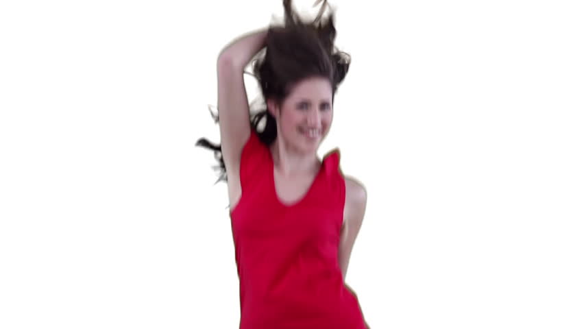 Woman dancing energetically while stroking her hair against a white background