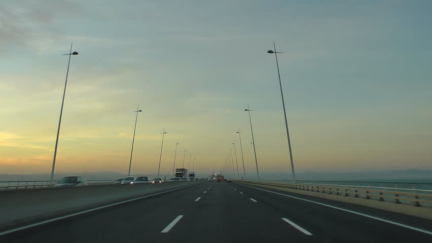 Driving car in highway at sunset