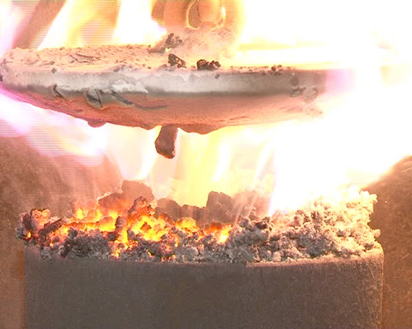 closeup of burning straw granules in boiler. flames and fire details. ecologic fuel use for house heating.
