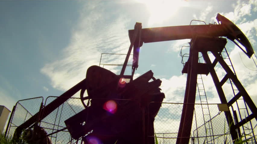 Mining.
Oil rig extracts resources from the earth. In the background a beautiful blue sky.