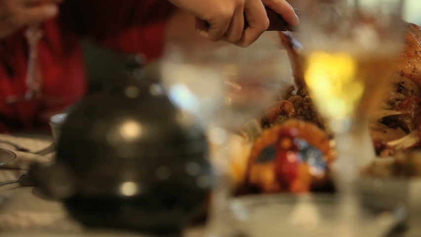 Family member carving the Thanksgiving turkey