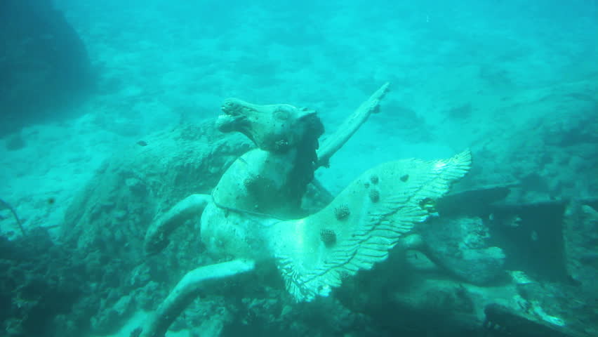 Underwater footage of pegasus and other debris left after a shipwreck on the bottom of the sea