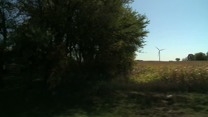 Trucking shot backlit wind farm