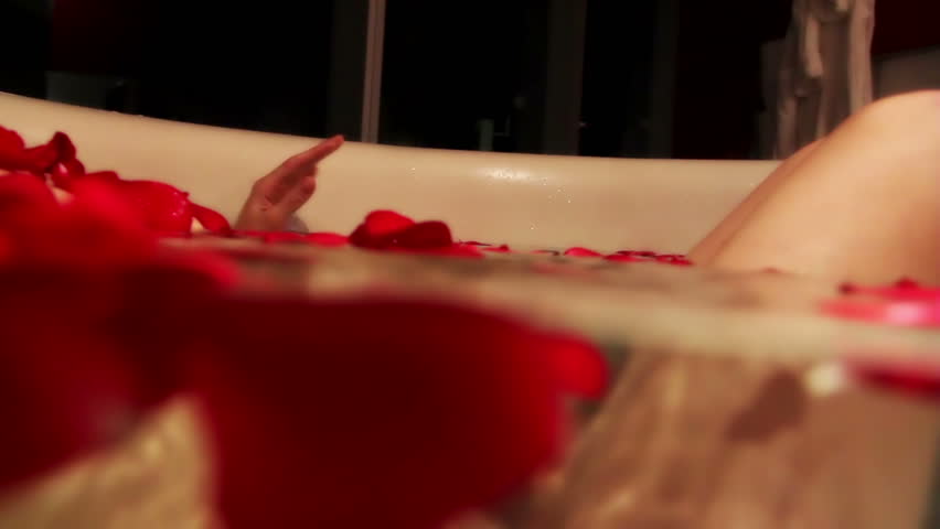 sexy beautiful woman in a large bath with rose petals