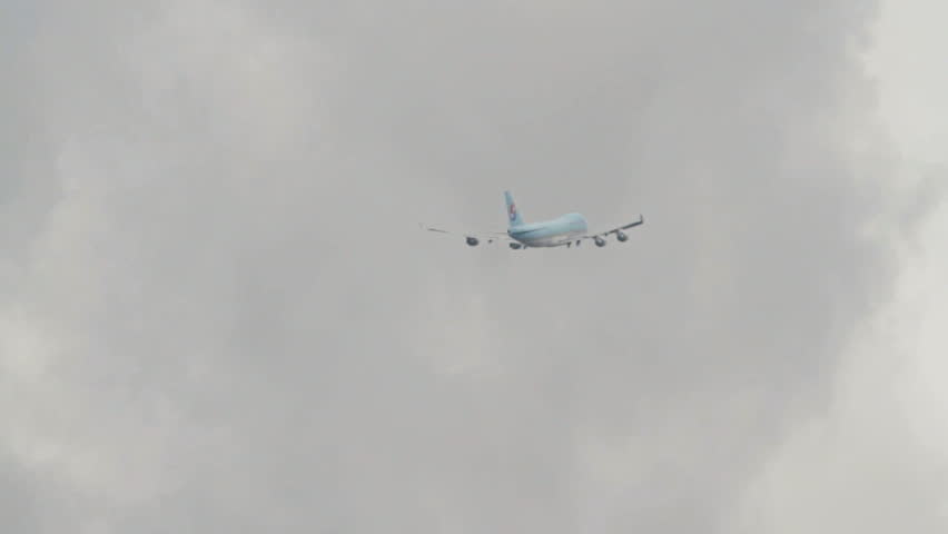 OSLO, NORWAY - MAY 2012: Korean Air Cargo, Boeing 747-400 freight airplane in flight among clouds, disappear at the end with huge wake turbulence