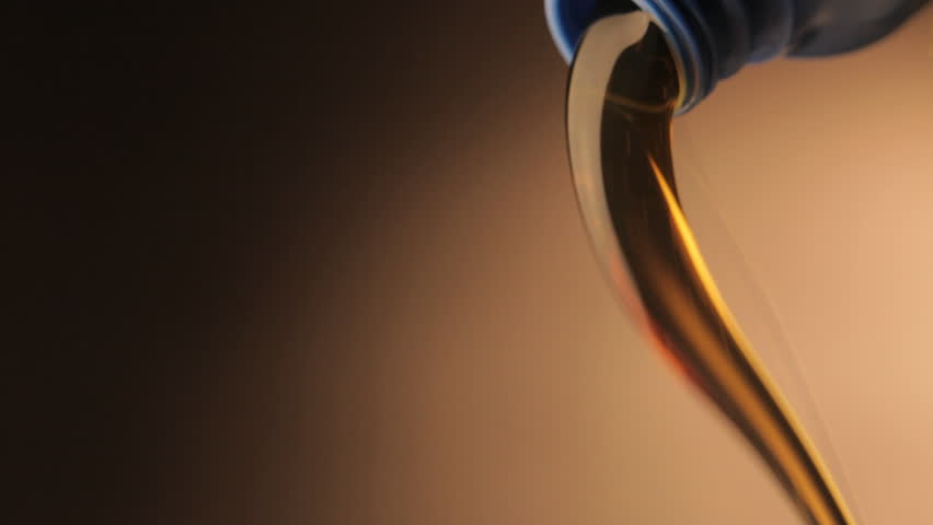 new clean oil pouring out of a can