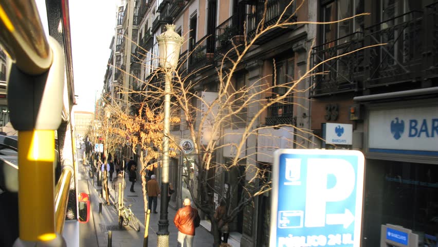 MADRID - MAR 10: (Timelapse View) Bus goes along streets on which people walk, on Mar 10, 2012 in Madrid, Spain