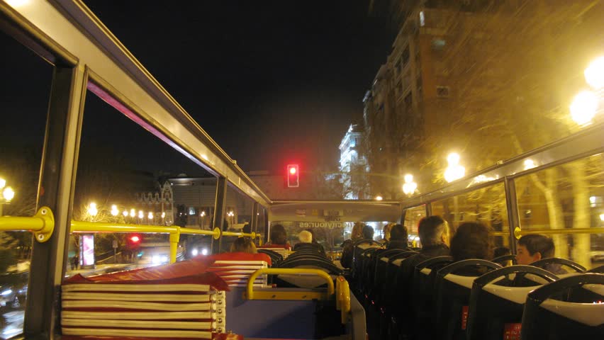 MADRID - MAR 10: (Timelapse View) Passengers go on night city in open bus, on Mar 10, 2012 in Madrid, Spain