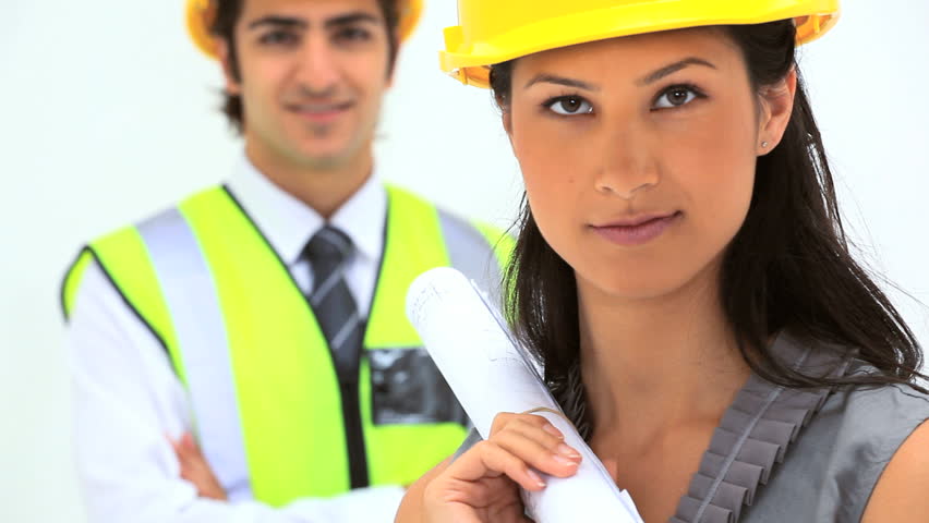 Two business people with safety helmet against white background