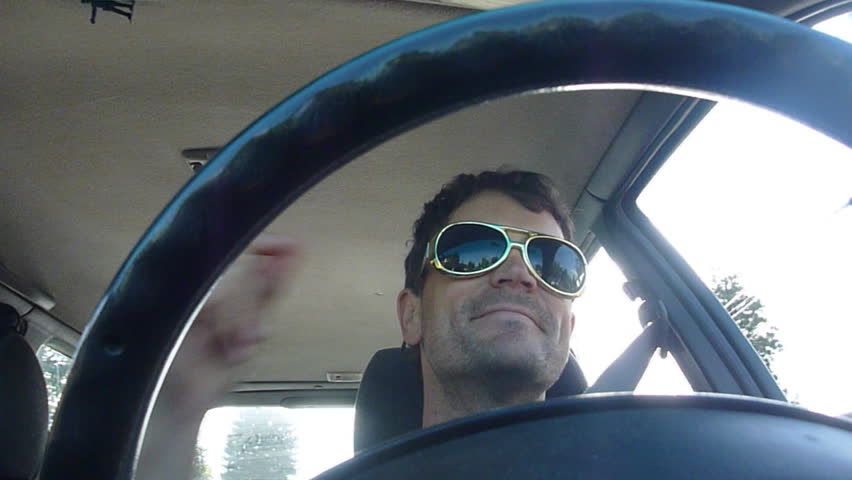 Funny clips of man driving car, dancing and listening to music.