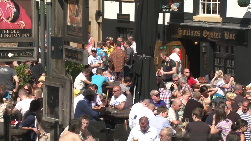 MANCHESTER - MAY 25: Drinkers sit outside English pubs on May 25, 2012 in Manchester, England.