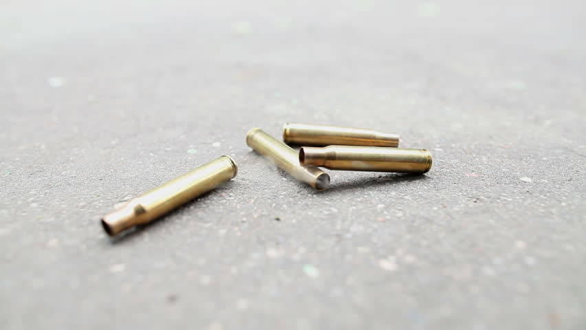 spent ammunition cartridges falling from a rifle