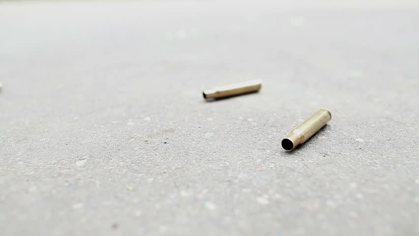 spent ammunition cartridges falling from a rifle