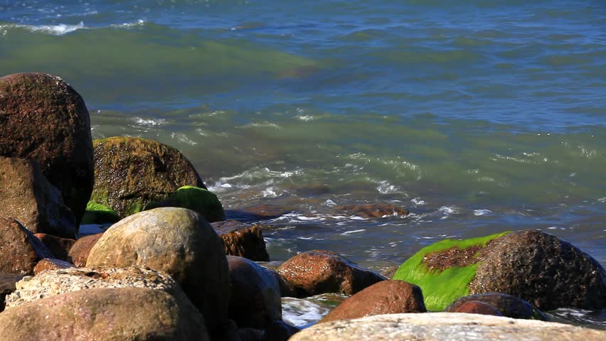 Close up of waves crashing on stony Beach Shore on the german Baltic Sea