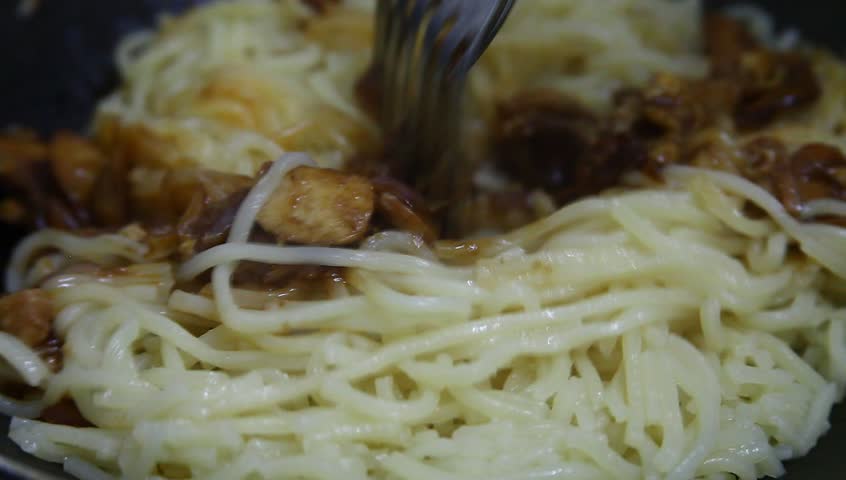 Cooking asian delicacy (fried noodle/mee goreng) in high definition (HD)